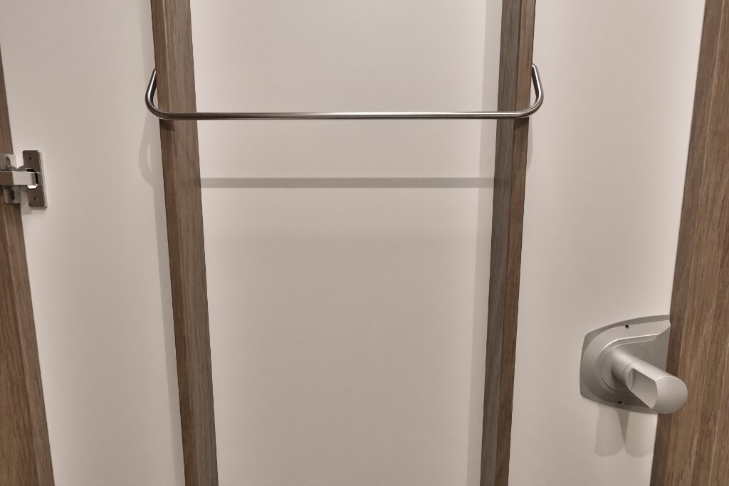 Wardrobe in the Carado motorhome with two wooden strips and a metal rail