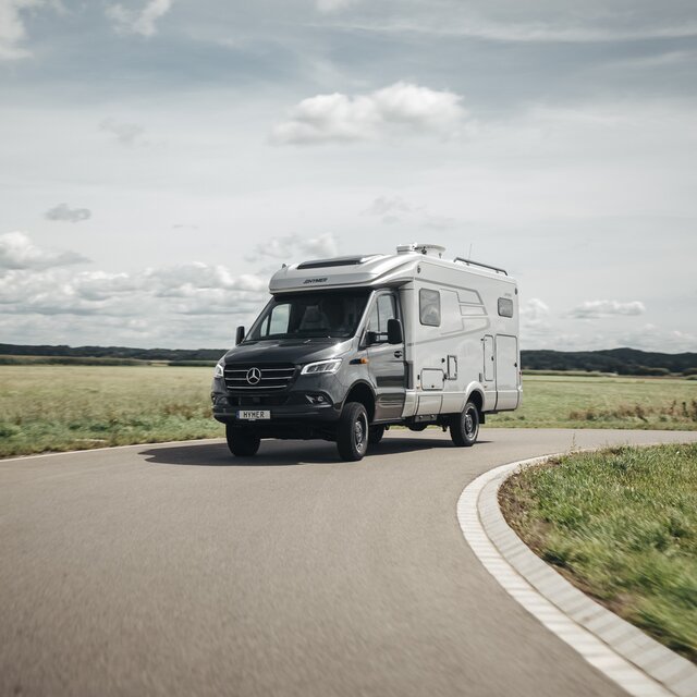 HYMER ML-T syns framifrån när den kör runt en kurva.
